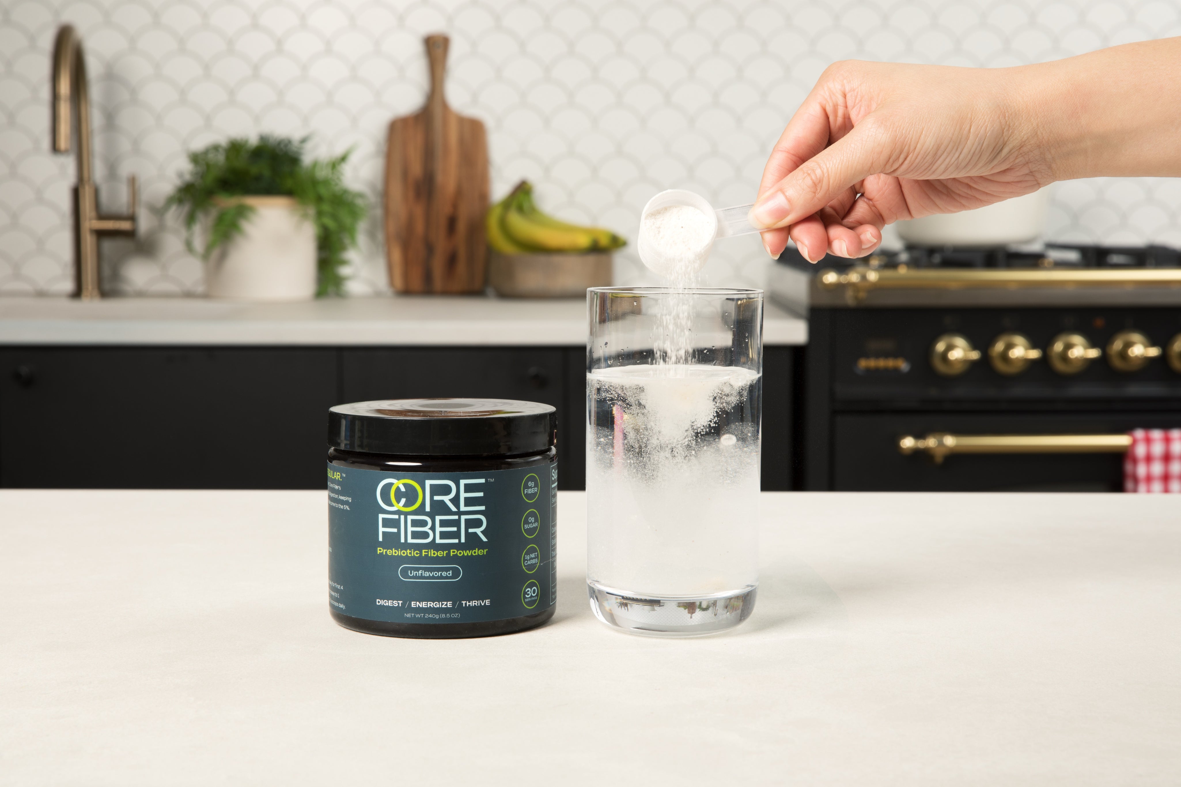 CORE FIBER Unflavored prebiotic fiber powder being mixed into water
